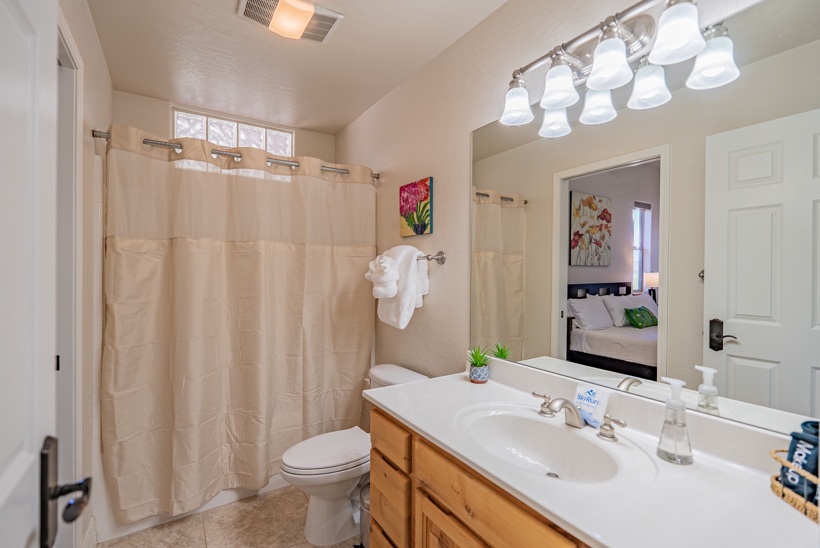 Step into your pristine bathroom featuring a spacious shower, elegant vanity, and thoughtful amenities for your comfort.