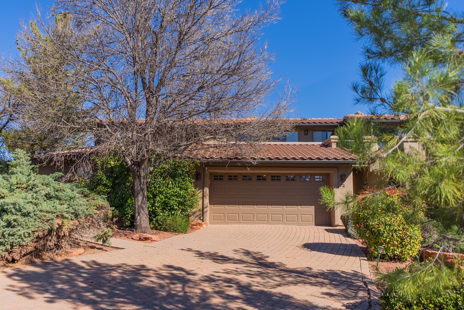 Charming home bordered by desert landscaping
