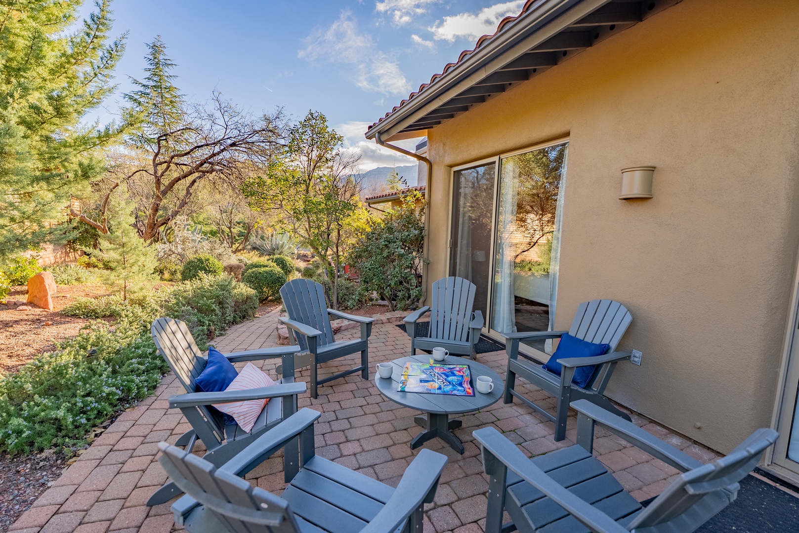 Unwind on your private patio with comfortable seating surrounded by lush desert gardens and peaceful mountain views.