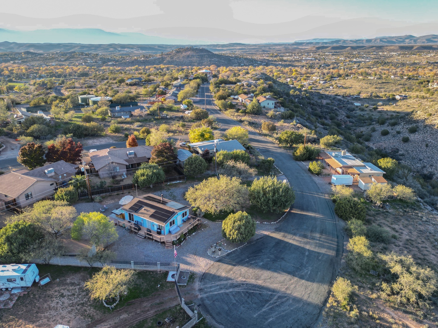 Aerial view of the property nestled in Arizona's scenic desert landscape, surrounded by mountains and natural vegetation in a peaceful residential area.