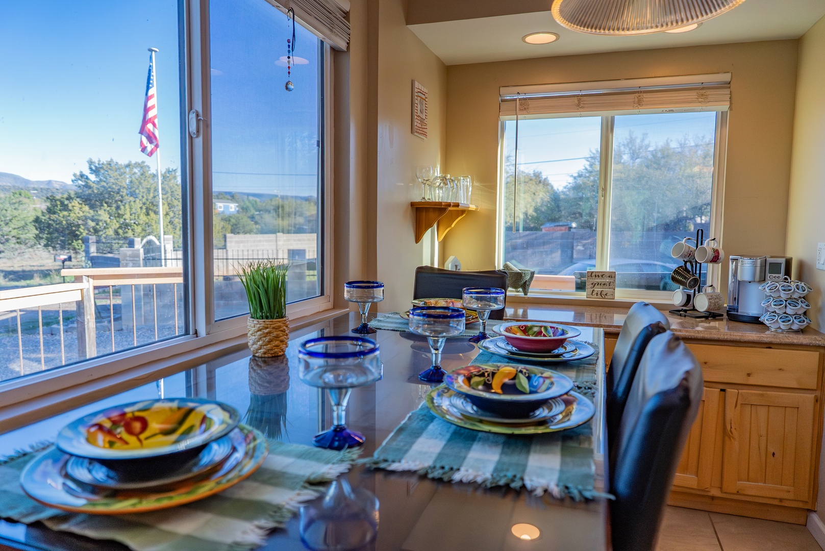 Gather around the elegant dining table where colorful place settings and sparkling glassware create the perfect setting for your memorable meals together.