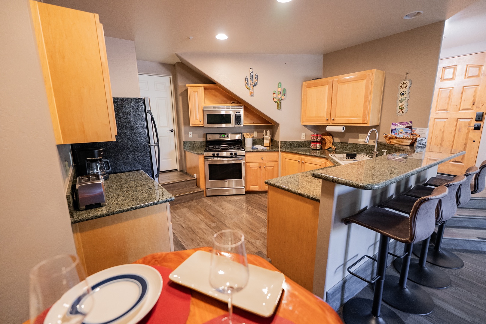 Your spacious kitchen awaits with granite countertops, stainless steel appliances, and a breakfast bar where you can sip morning coffee.