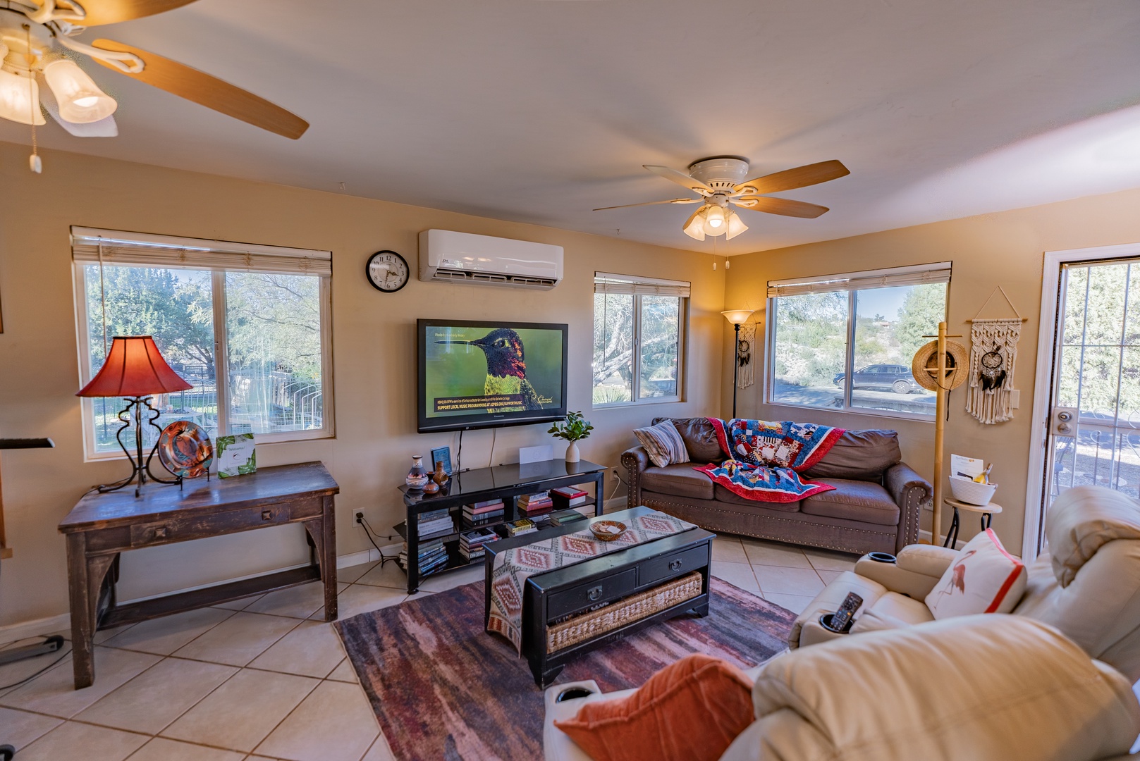 Relax in your spacious living room with comfortable seating, flat-screen TV, and large windows that fill the space with natural light throughout the day.