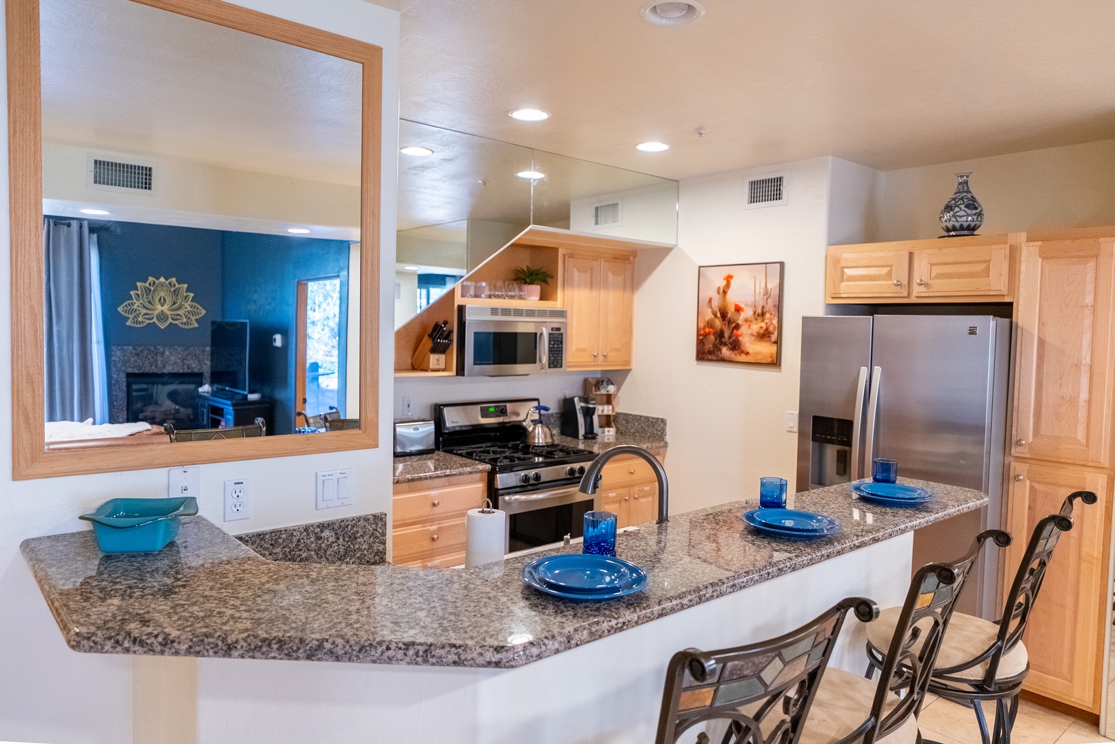 Your fully equipped kitchen opens to the living area, perfect for cooking together and sharing meals around the granite breakfast bar.