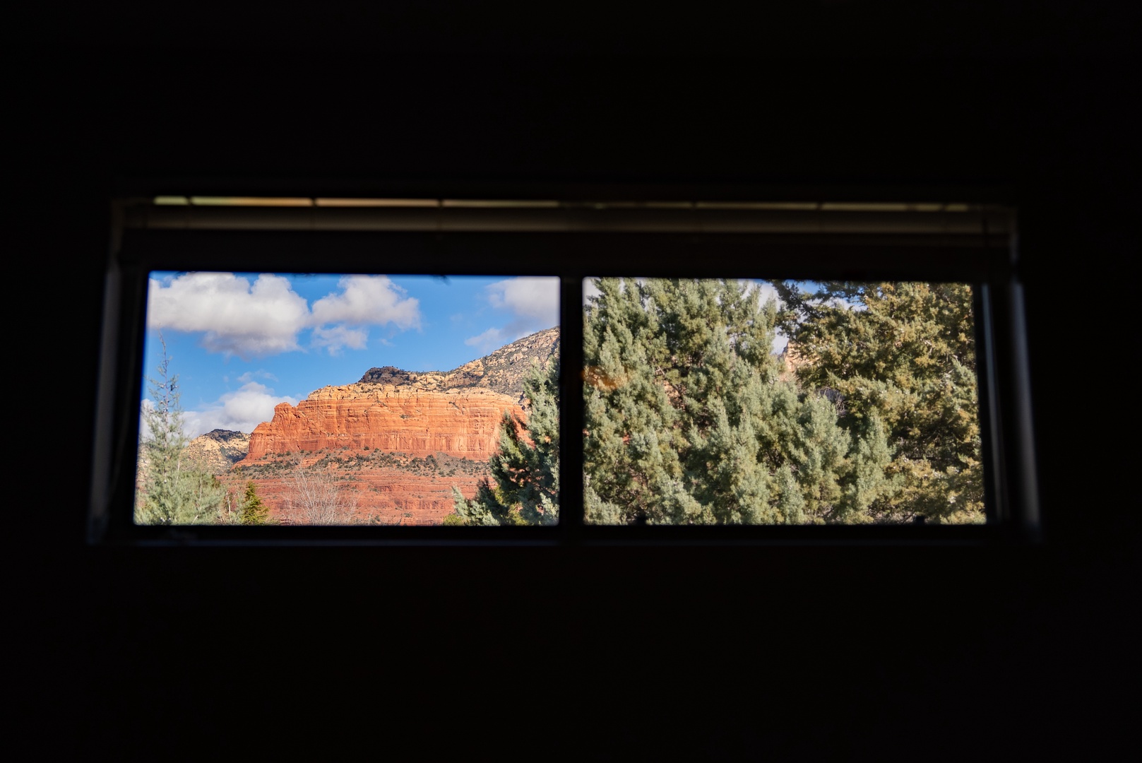Wake up to breathtaking red rock formations framed perfectly through your bedroom window—nature's masterpiece awaits you every morning.