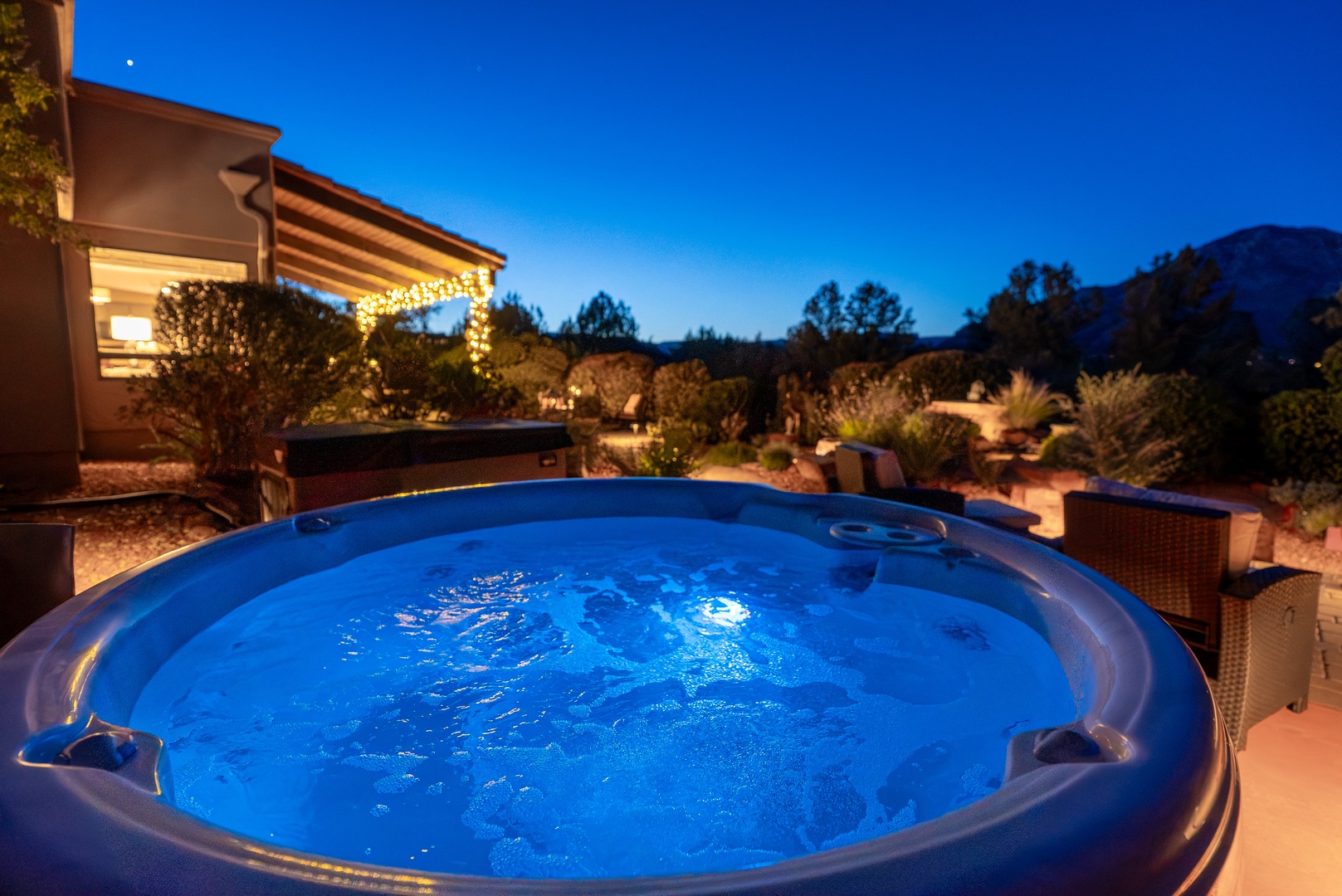 A tranquil twilight retreat featuring a bubbling hot tub