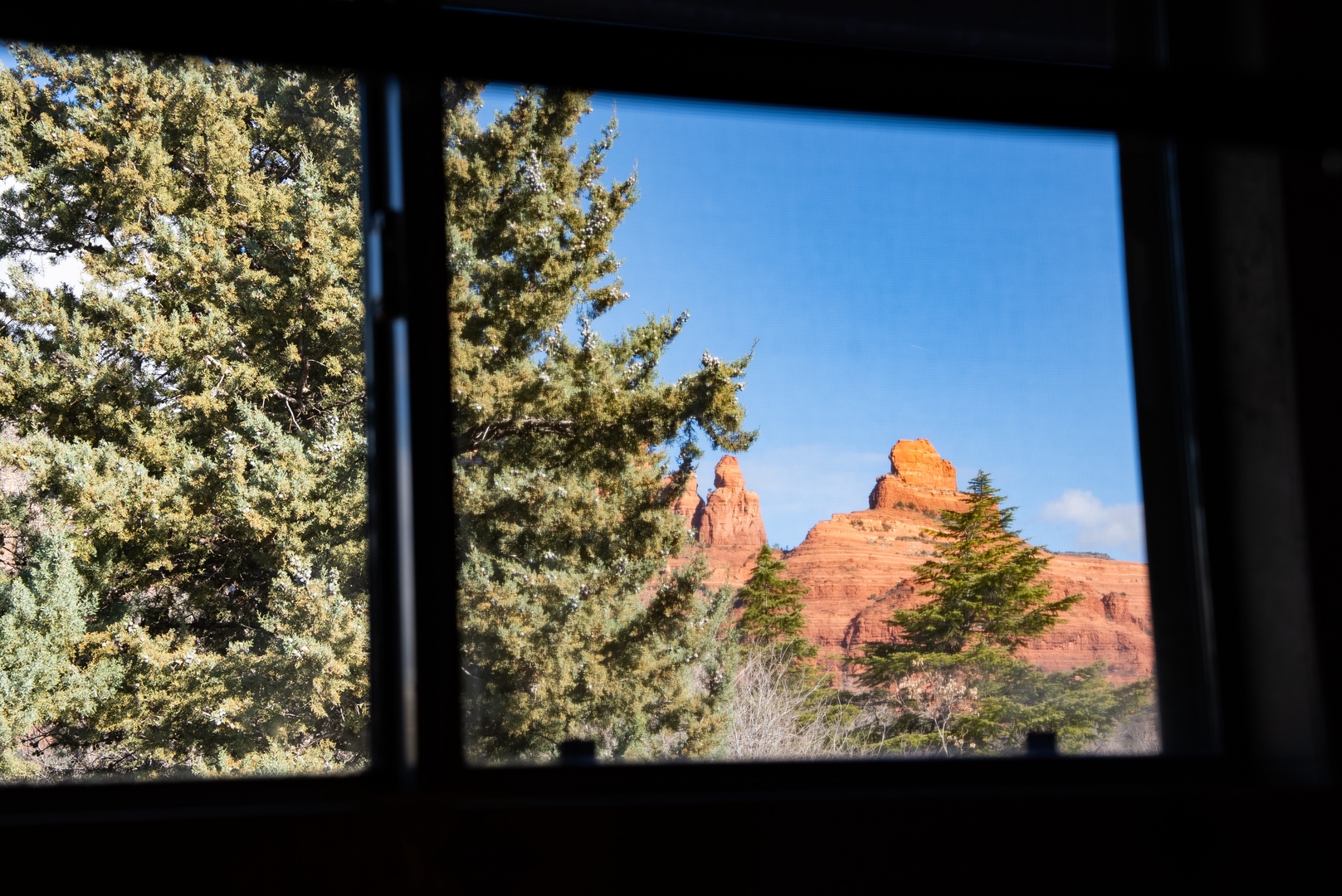 Wake up to breathtaking red rock formations framed perfectly by your window, where nature's masterpiece greets you each morning.