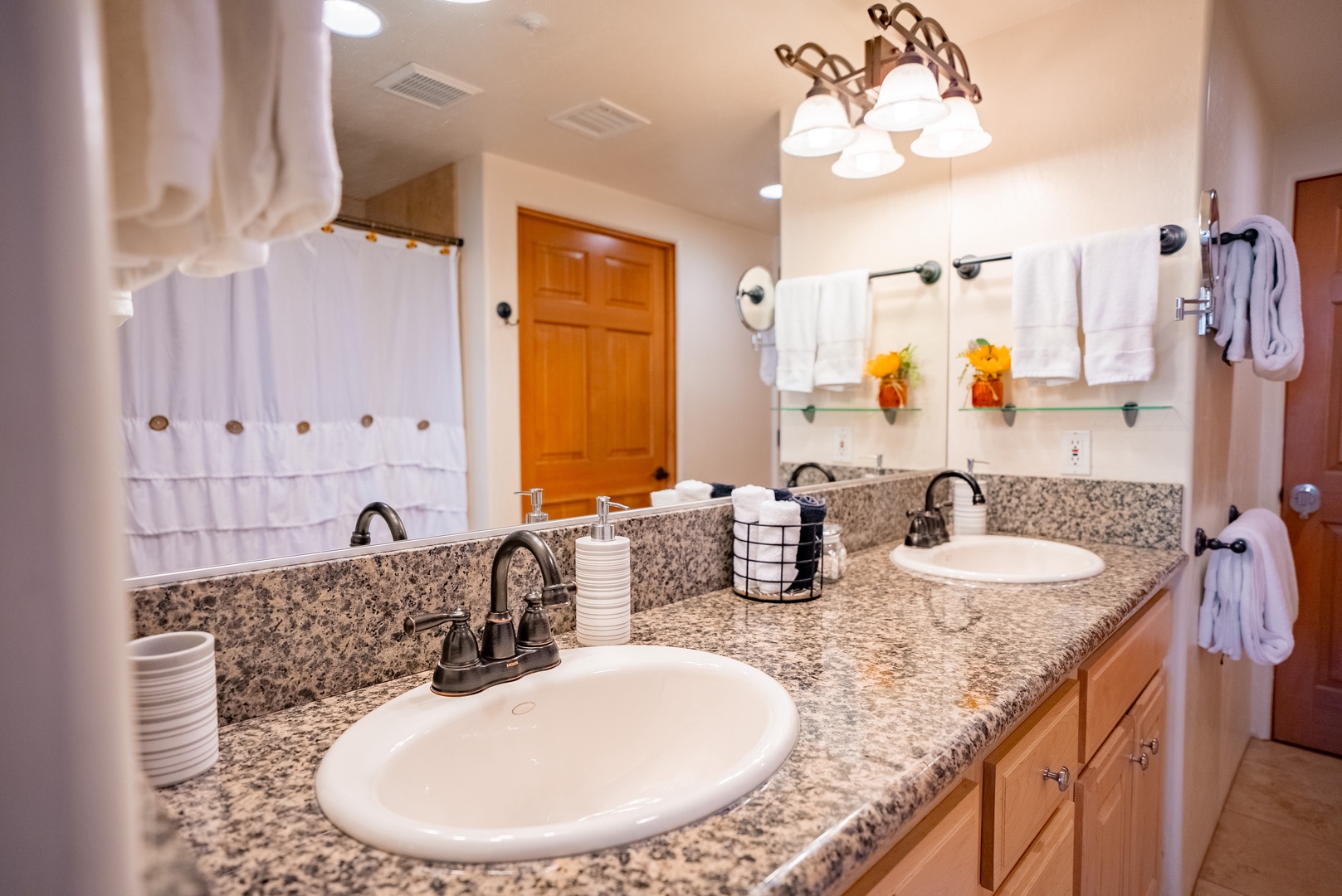 Step into your spacious master bathroom with granite counters, dual sinks, and plush white towels ready for your comfort.