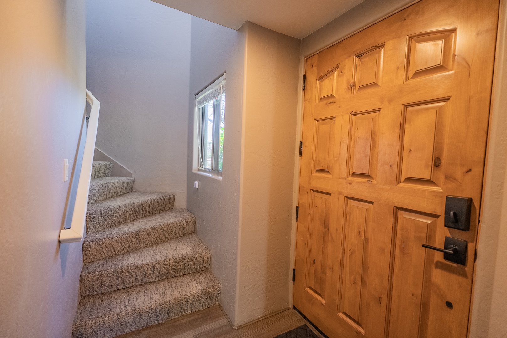 Step through your welcoming entrance with beautiful wood doors, then climb carpeted stairs to discover your comfortable retreat above.