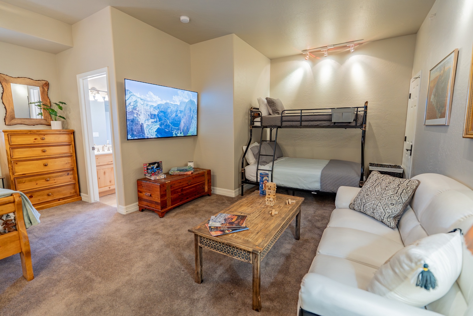 Your cozy living space features comfortable seating, entertainment center with large TV, and convenient bunk beds for extra guests.