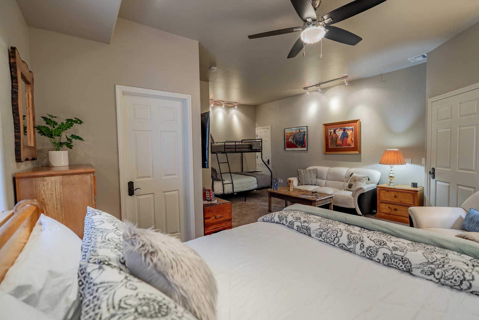 Relax in your spacious bedroom with a comfortable king bed, cozy seating area, and bunk beds for extra guests.