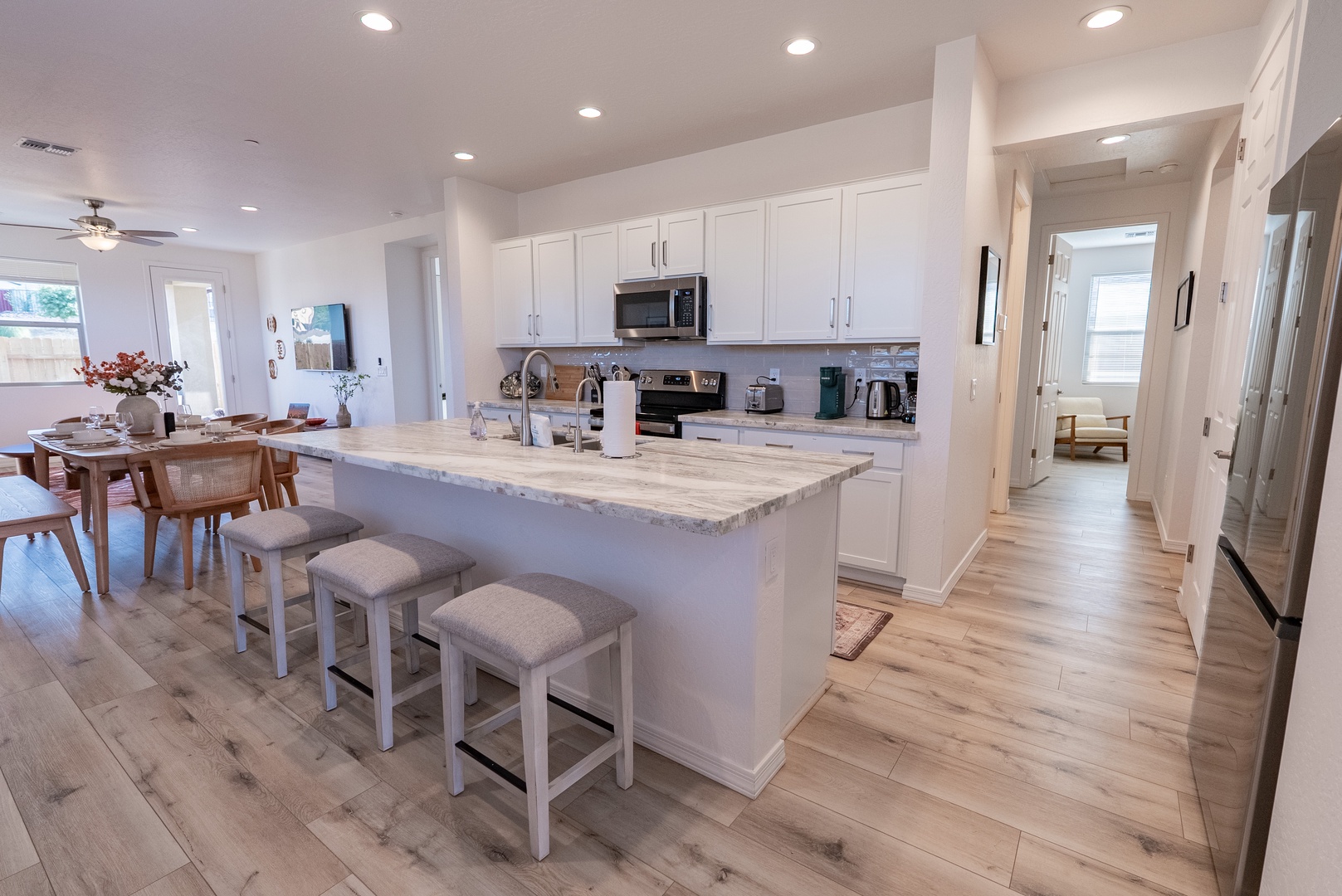 Open kitchen with marble countertops and new appliances