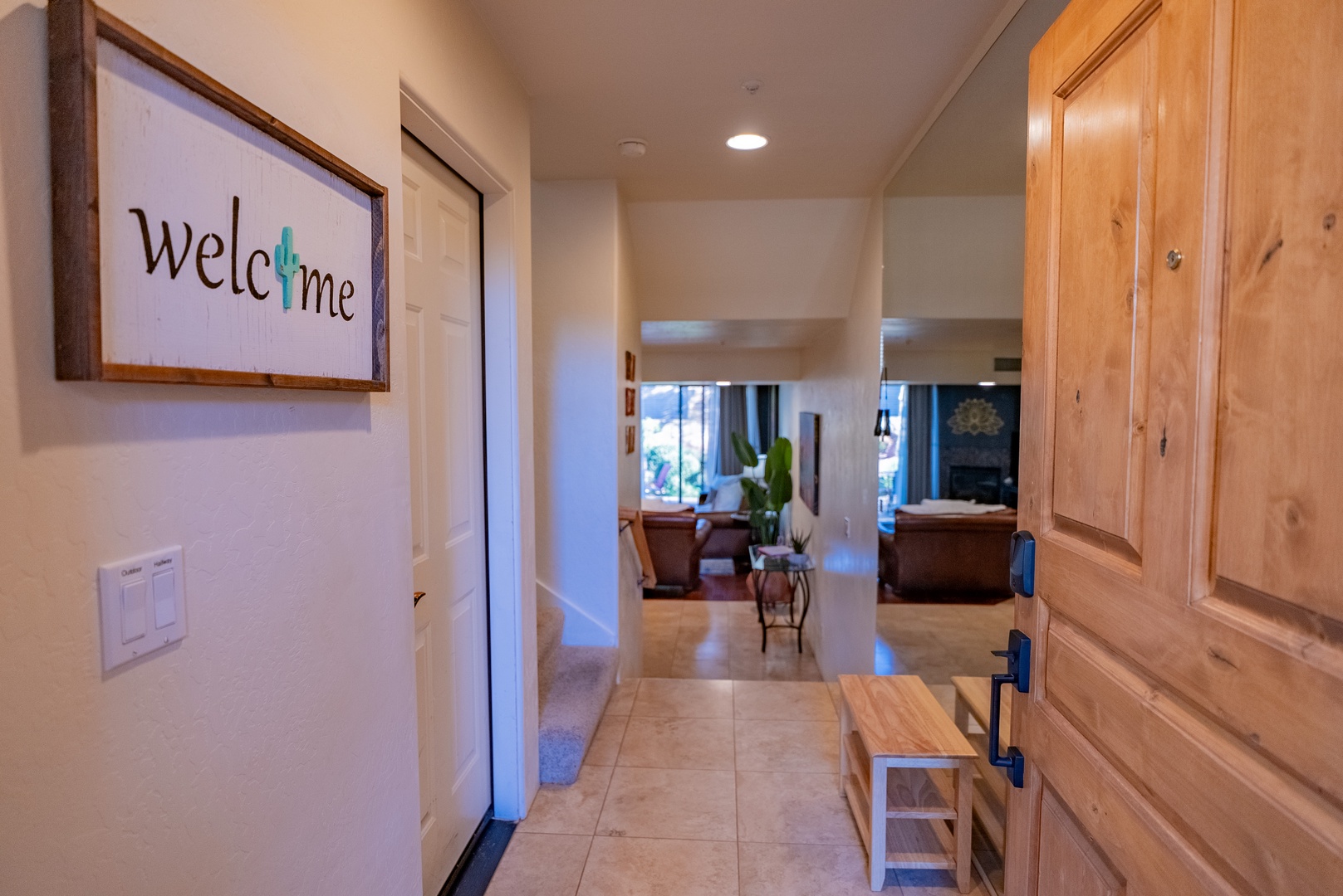 Step through the welcoming entryway featuring warm wood tones and thoughtful touches that make you feel instantly at home.