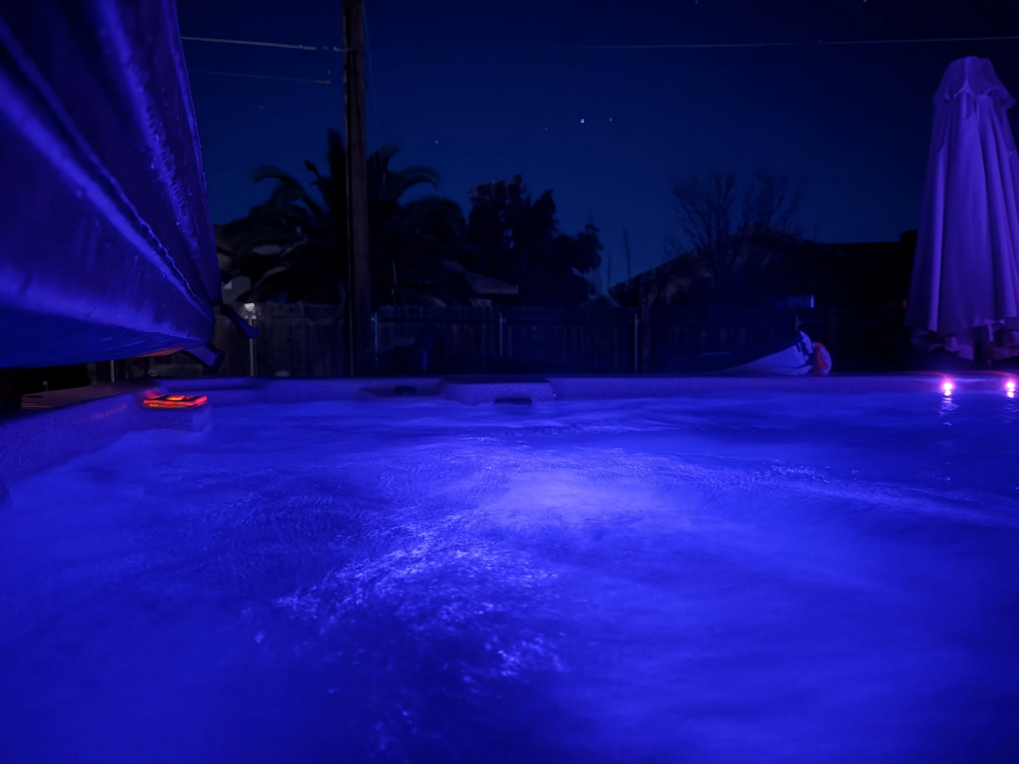 Dive into your private evening escape - the pool glows with enchanting blue lighting, creating the perfect ambiance for a magical nighttime swim.