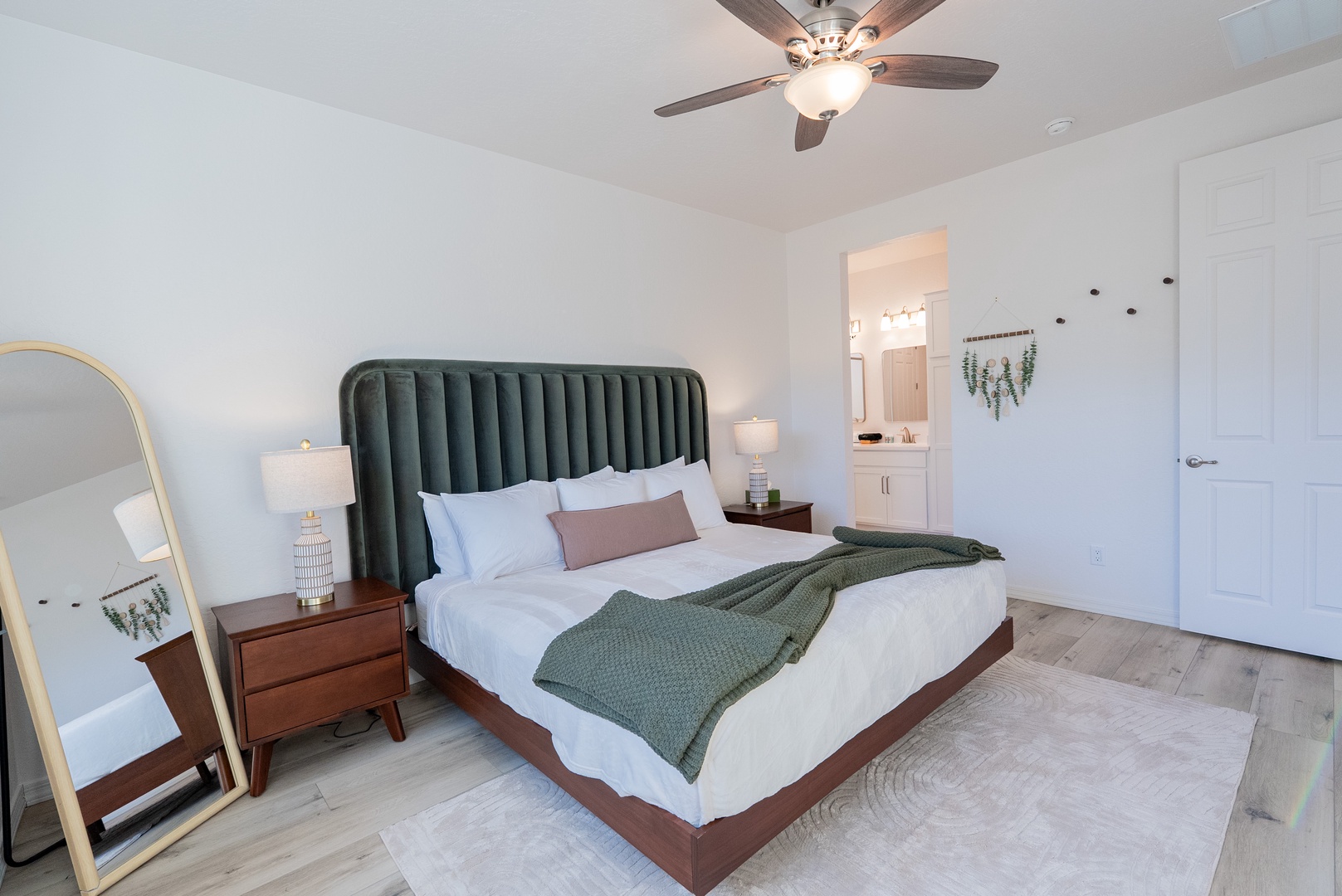 Rest on a plush king bed with its stylish emerald headboard