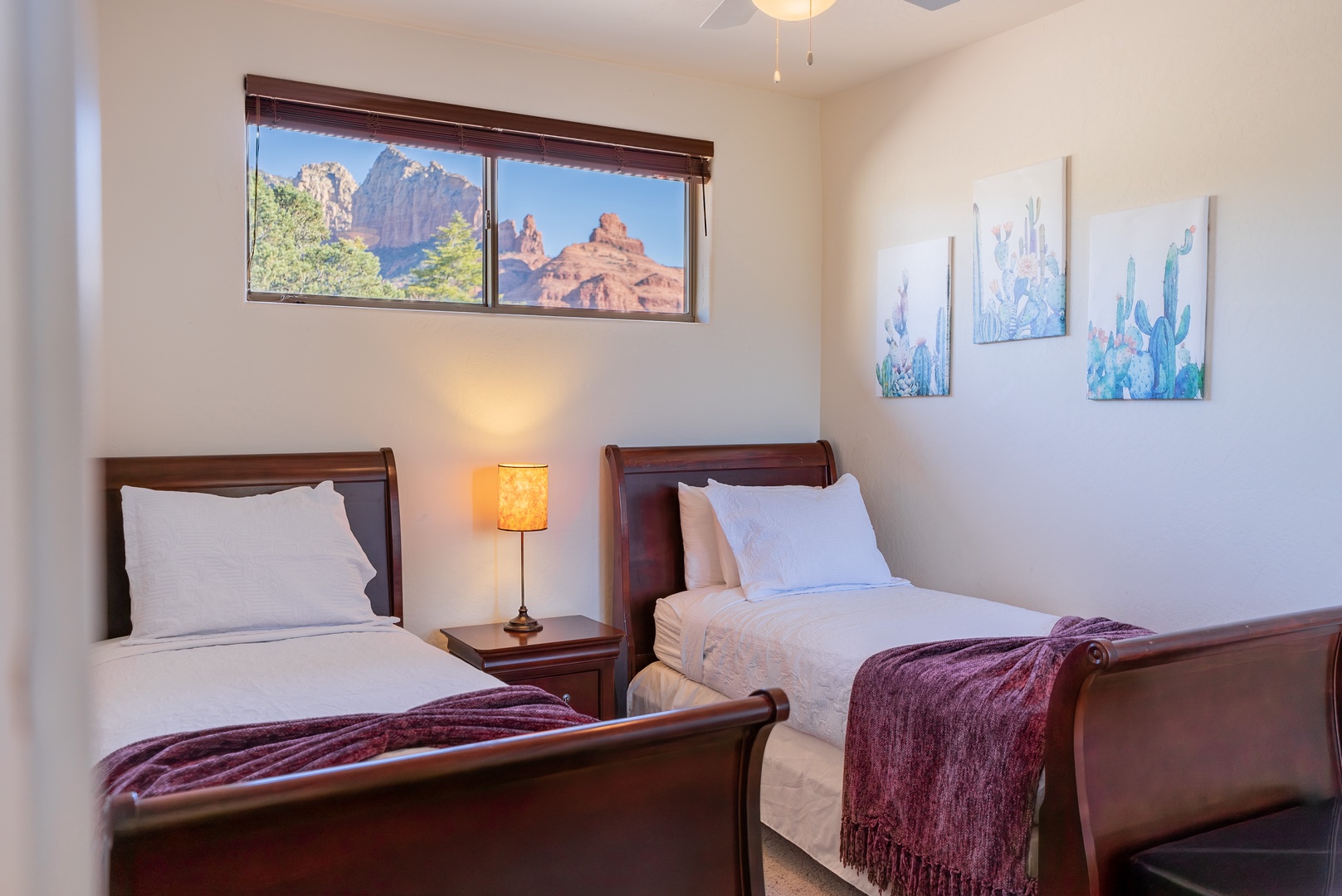 Wake up to stunning red rock views from your comfortable twin beds, where desert artwork and warm lighting create your perfect retreat.