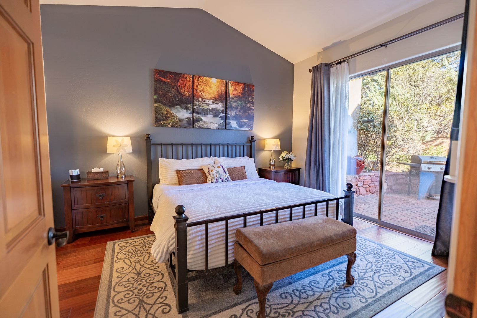 Drift into peaceful slumber in your elegant bedroom, where crisp linens meet warm wood accents and garden views promise tranquil mornings.