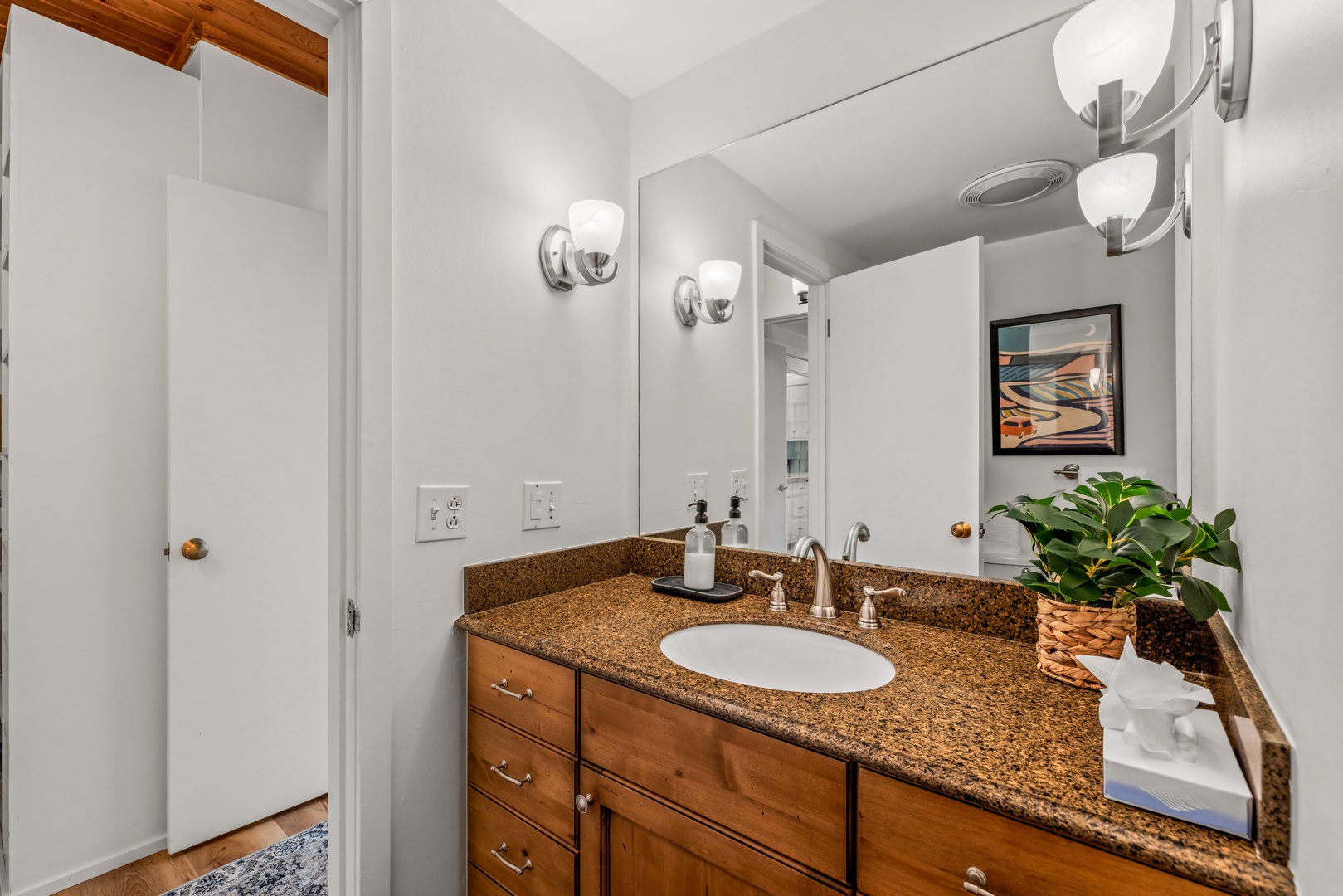 Freshen up in your well-lit bathroom with its warm granite countertops, ample storage, and modern fixtures creating a comfortable sanctuary for your morning routine.