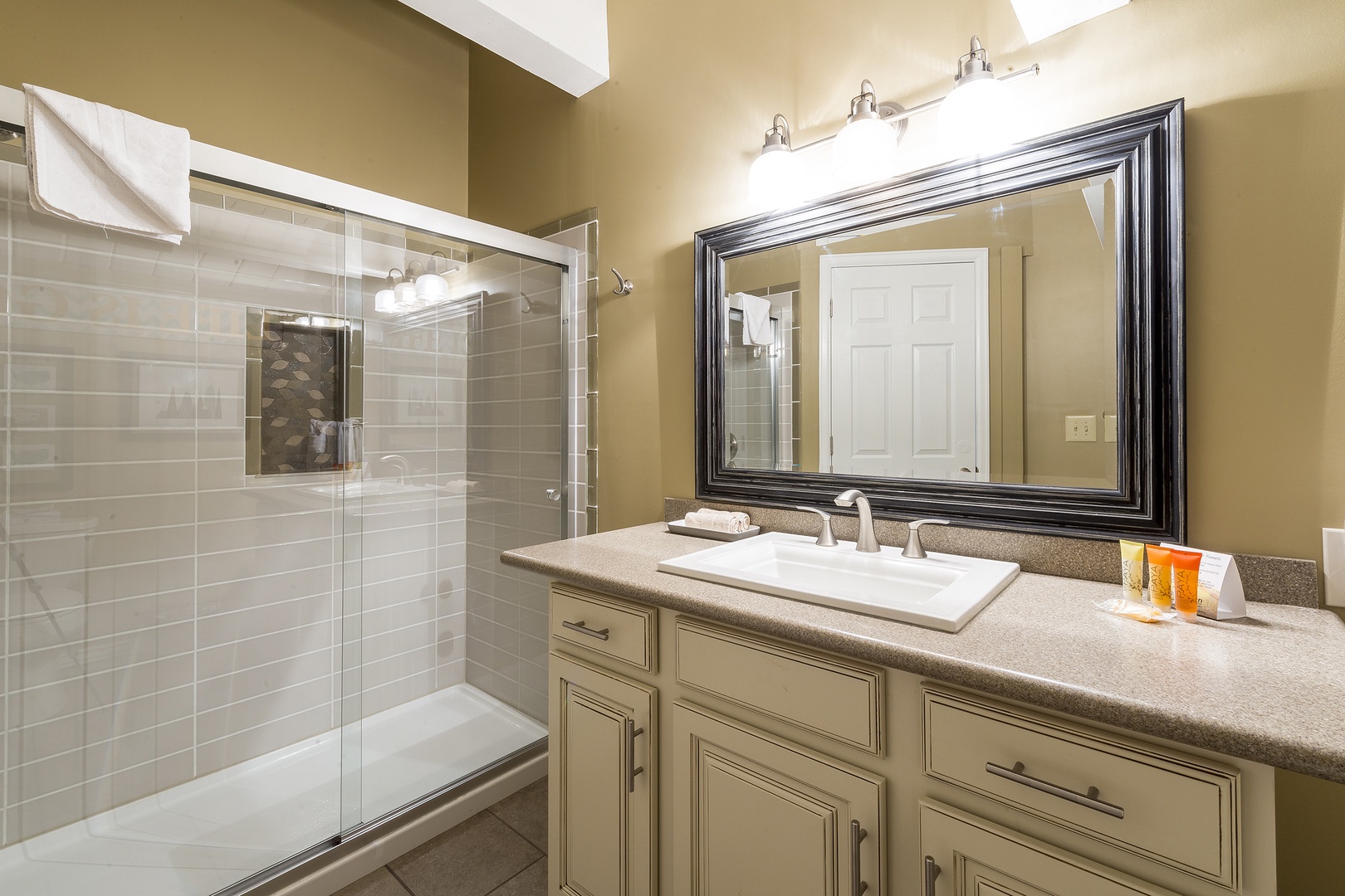 Step into your beautifully appointed bathroom with sleek subway tile, a spacious glass-enclosed shower, and ample vanity space for your morning routine.