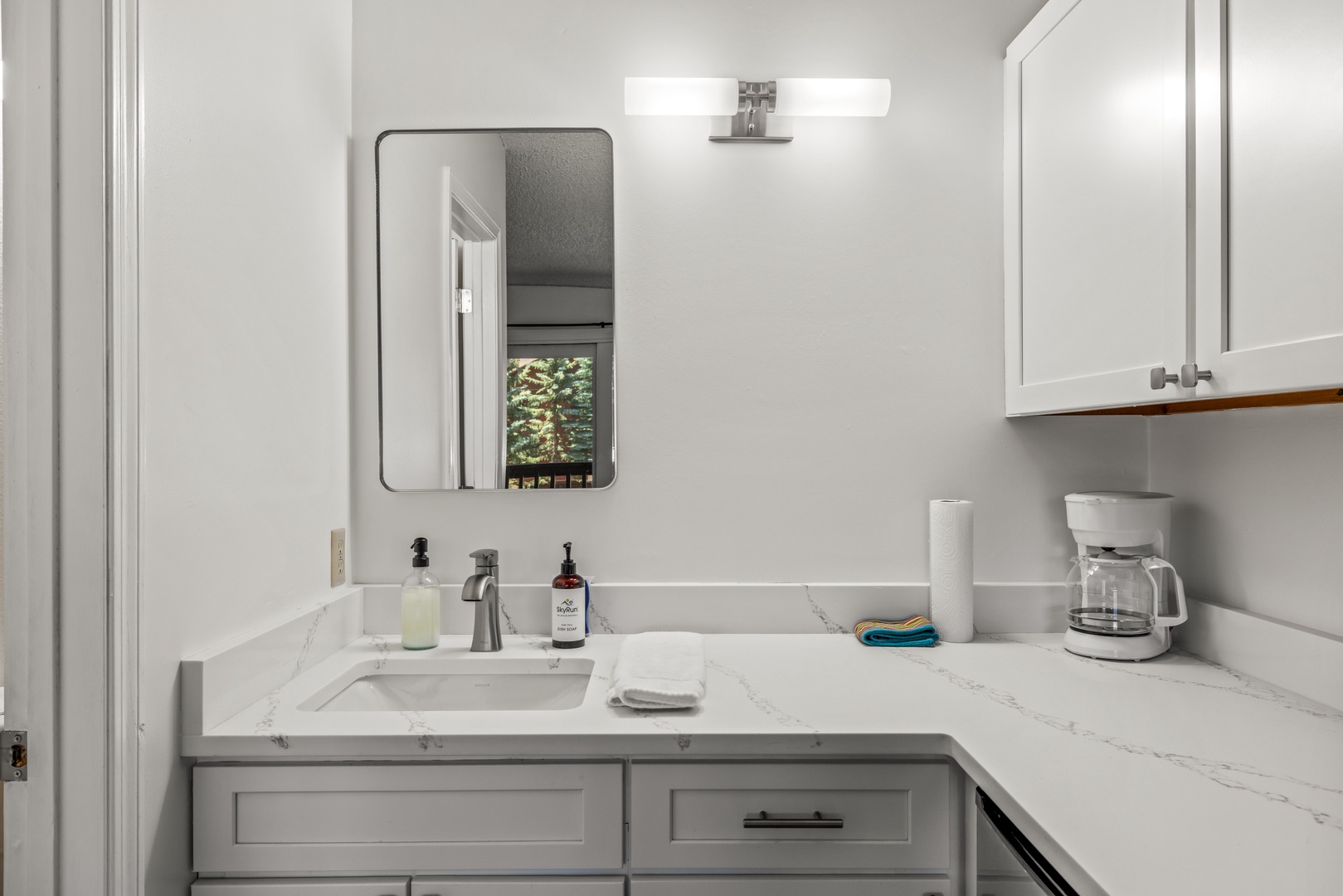 Step into your elegantly refreshed bathroom with sparkling marble countertops, modern vanity storage, and thoughtful touches like fresh towels and premium soap waiting just for you.