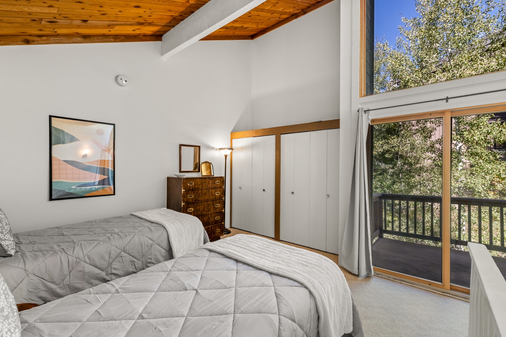 Wake up to treetop views and natural light streaming through the glass doors. Your private retreat features soaring wood ceilings and a peaceful setting where you can truly unwind.