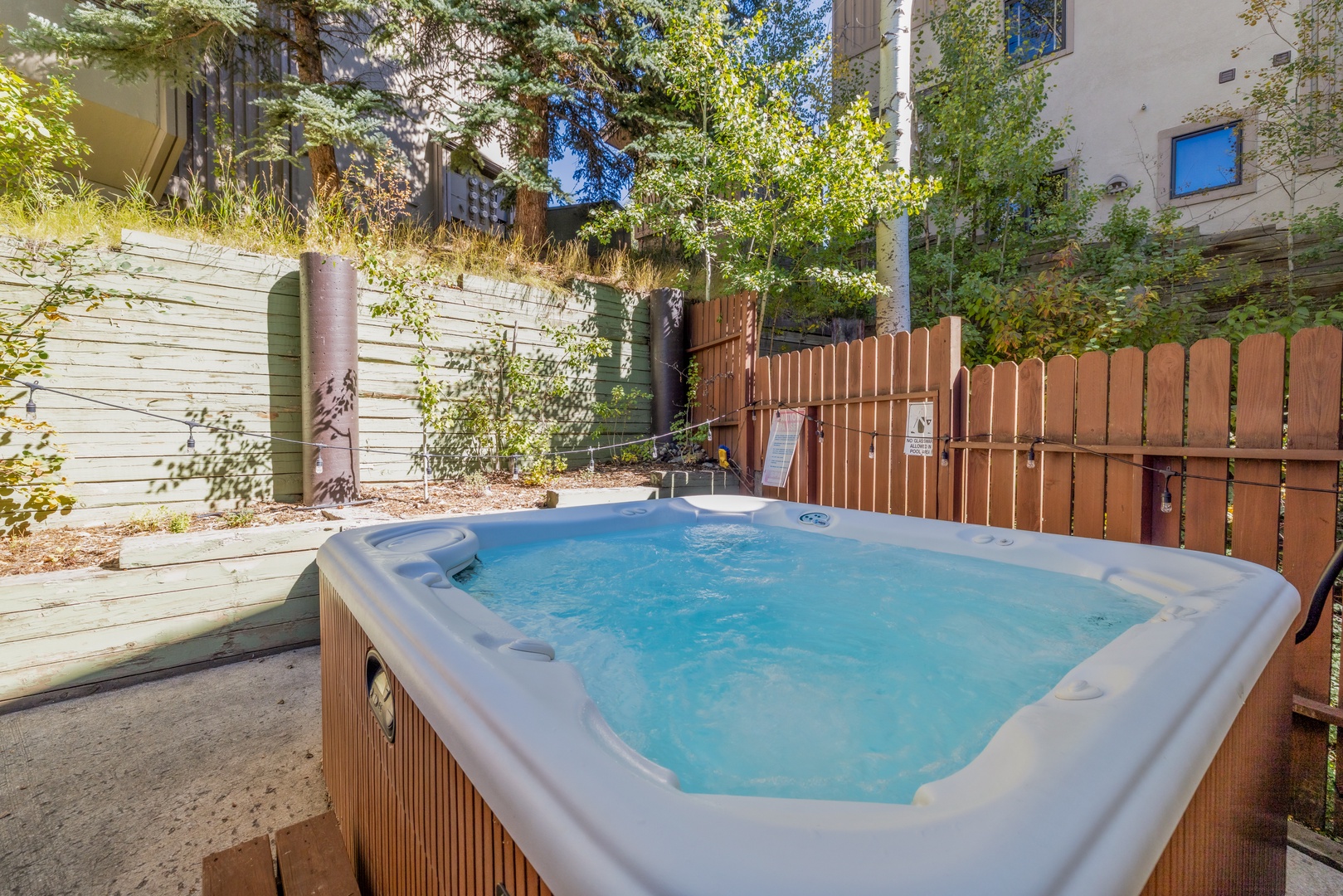 Slip into your private hot tub and soak away the day, surrounded by leafy greenery and the gentle warmth of the sun filtering through the trees.