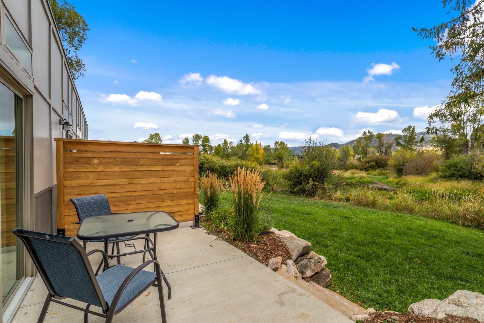 Step outside to your private patio and soak in breathtaking mountain views, where lush meadows and distant peaks create the perfect backdrop for your morning coffee or evening wind-down.