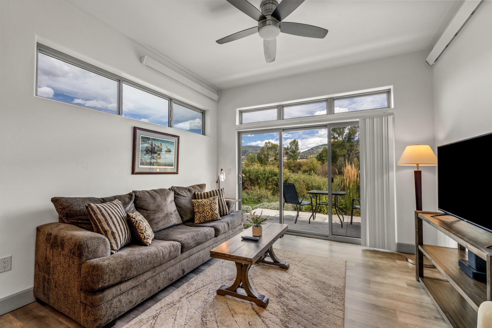 Settle into your comfortable living space where tall windows frame stunning mountain and garden views. Step through the glass doors to your private balcony and breathe in the fresh air surrounded by nature.
