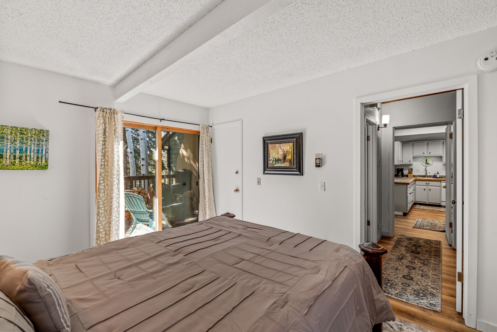 Drift off in your peaceful bedroom, where natural light filters in and glass doors open to your private outdoor space, inviting morning coffee or evening relaxation.