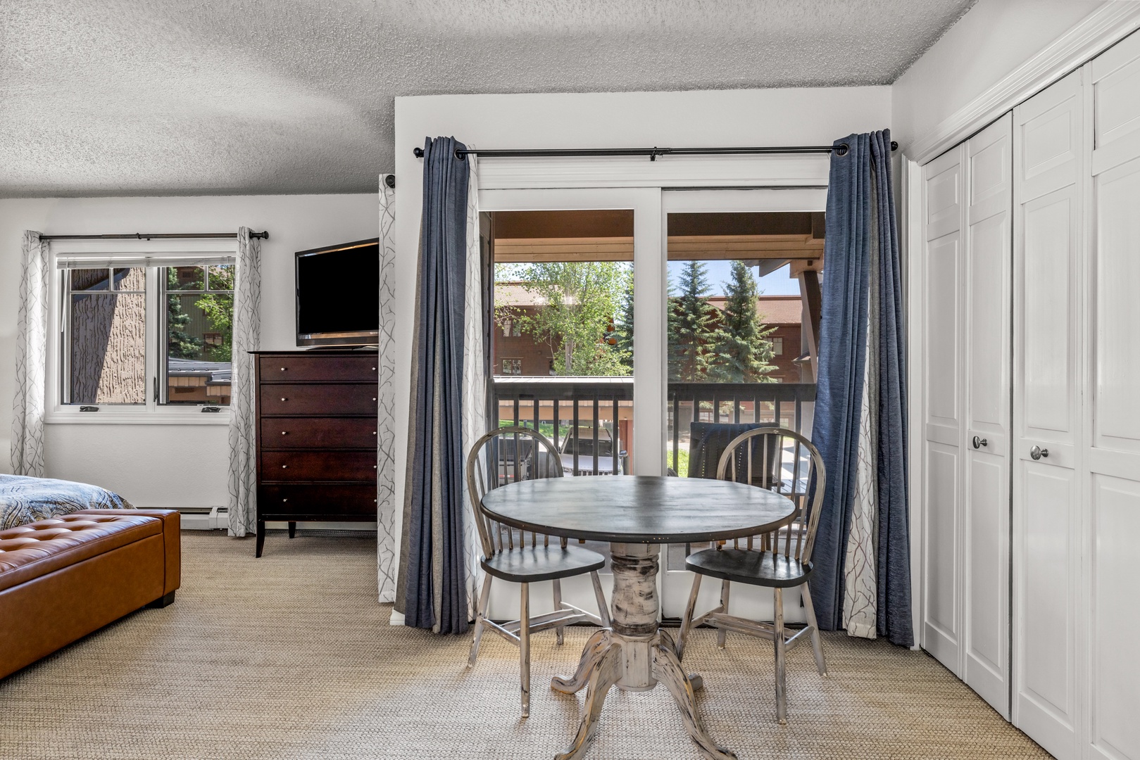 Your cozy studio blends comfort and function with a charming dining nook, inviting balcony views, and all the essentials for a relaxing mountain getaway.