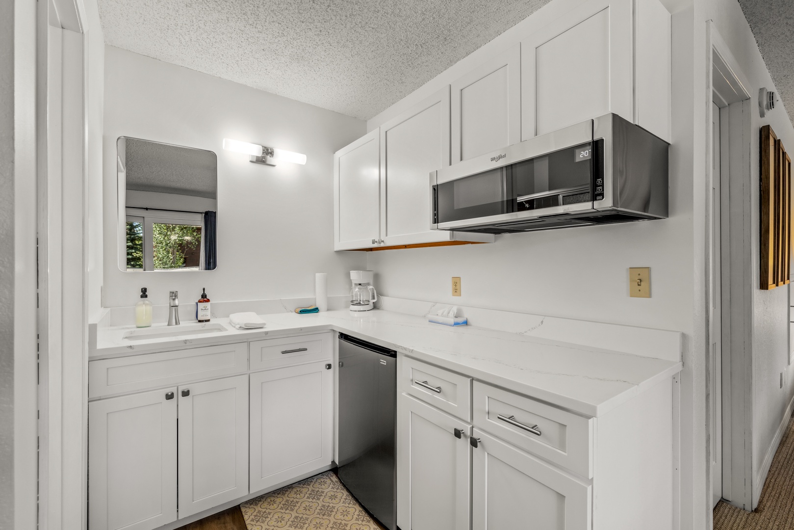 Your fully equipped kitchen features crisp white cabinetry, modern stainless appliances, and everything you need to prepare meals during your stay.