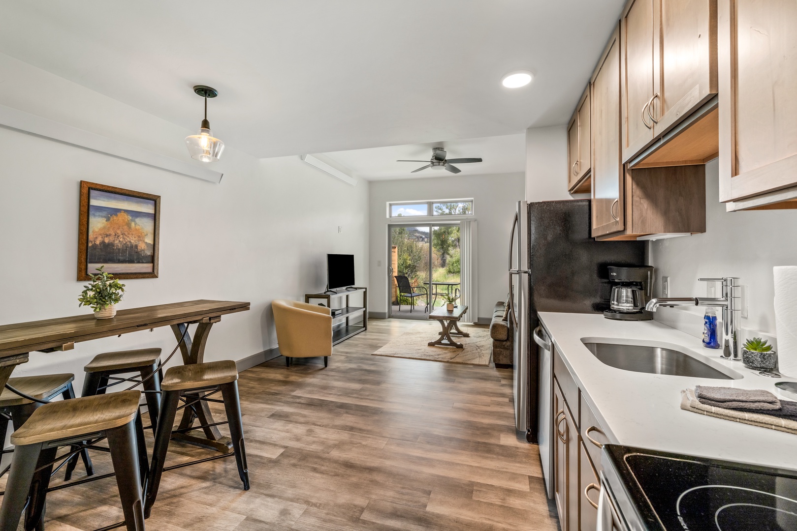 Step into your open-concept living space, where natural light pours in and everything you need is right at hand. The kitchen flows seamlessly into the dining and living areas, perfect for easy mornings and relaxed evenings at home.