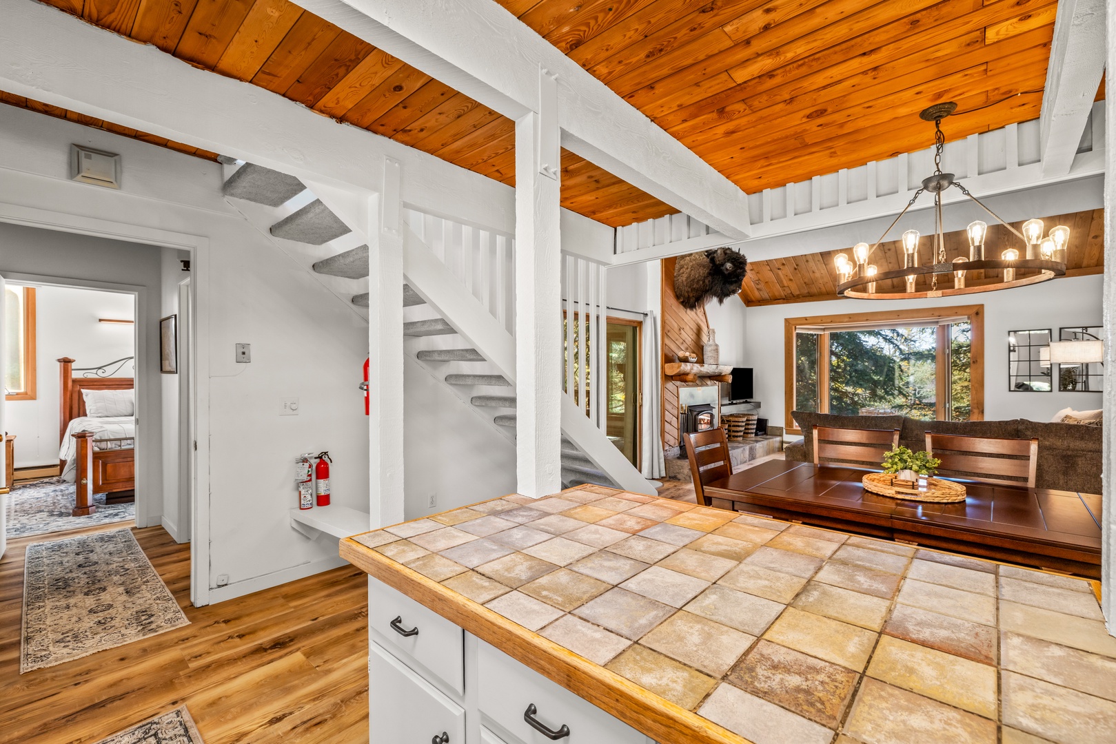 Step into your bright and airy retreat where soaring wood ceilings and an open floor plan create a sense of warmth and freedom. Natural light pours through large windows, inviting you to relax in comfort.