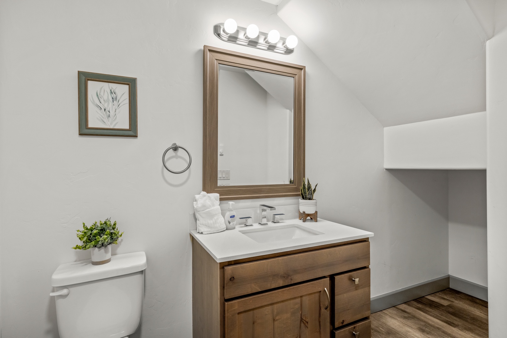 Step into your beautifully updated bathroom, where soft lighting and warm wood tones create a soothing retreat. Fresh towels await you, and thoughtful touches make your daily routine feel effortless and relaxing.