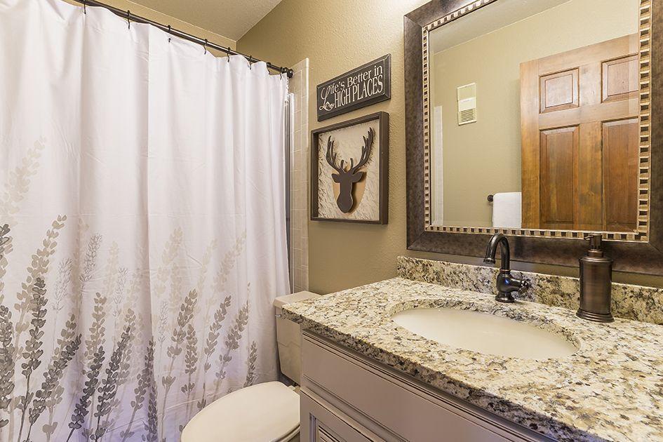 Step into a thoughtfully designed bathroom with elegant granite countertops, warm rustic accents, and all the comforts you need to unwind after exploring.