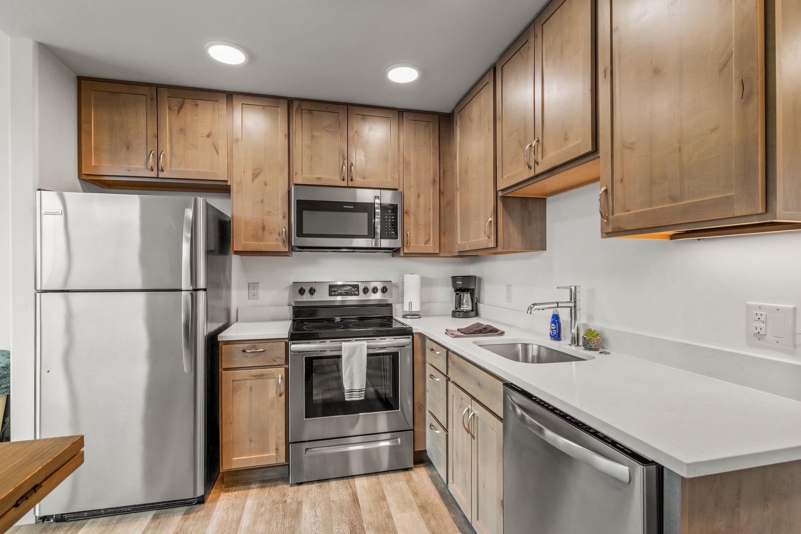 Your fully equipped kitchen features warm wood cabinetry, stainless appliances, and ample counter space for preparing meals just the way you like them.