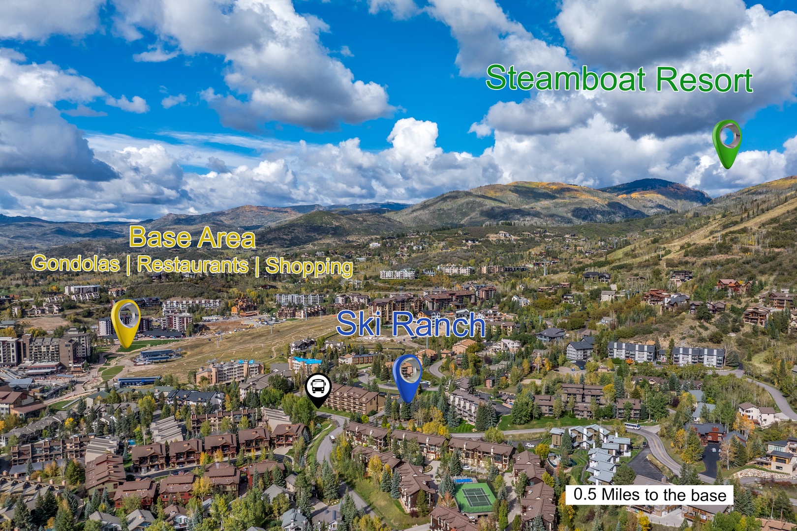 An expansive aerial perspective captures a mountain resort community nestled in the valley, with ski slopes, residential neighborhoods, and rolling hillsides defining the scenic landscape.