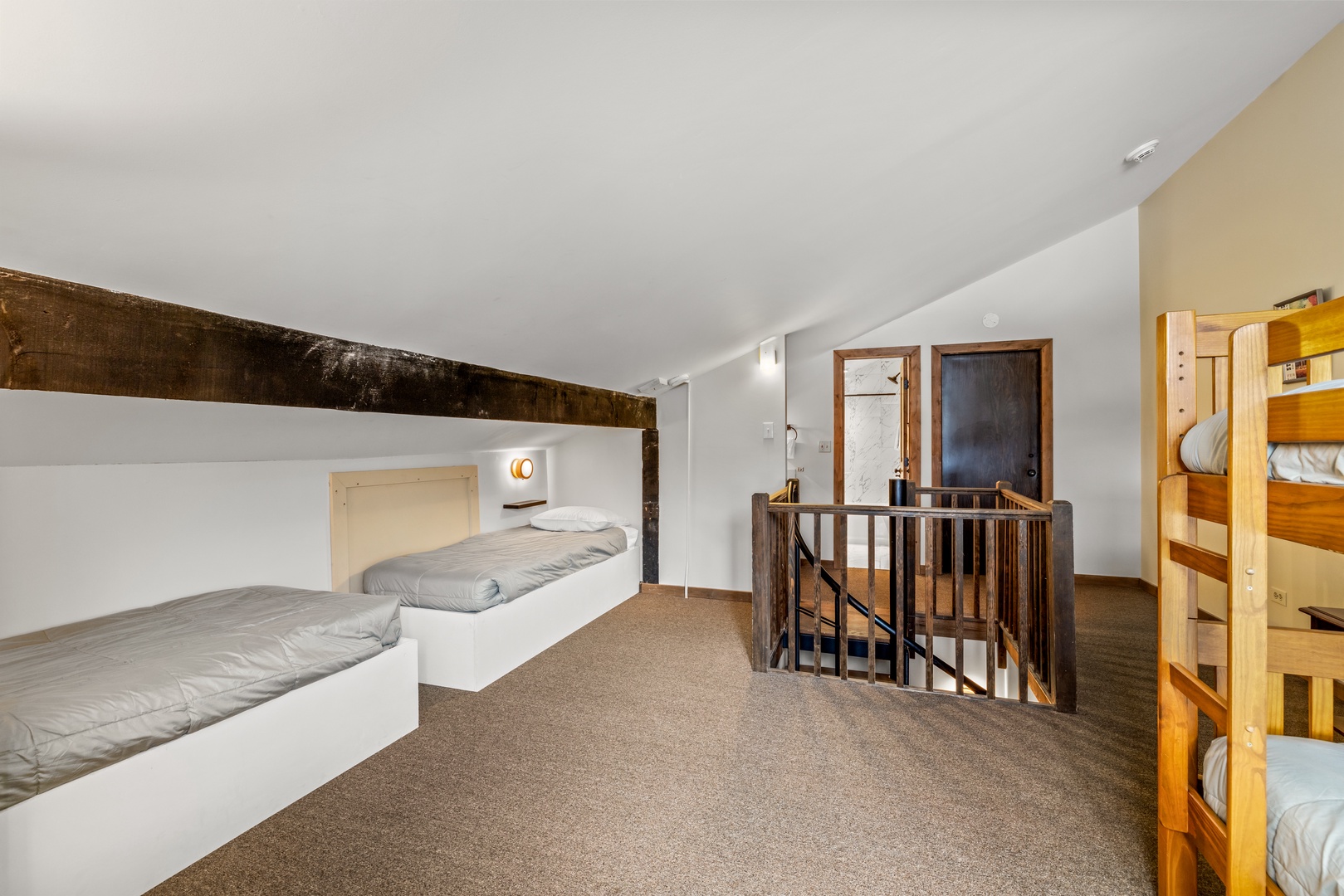 Your cozy loft retreat features built-in beds and warm wood accents, perfect for groups seeking comfort and rustic charm.