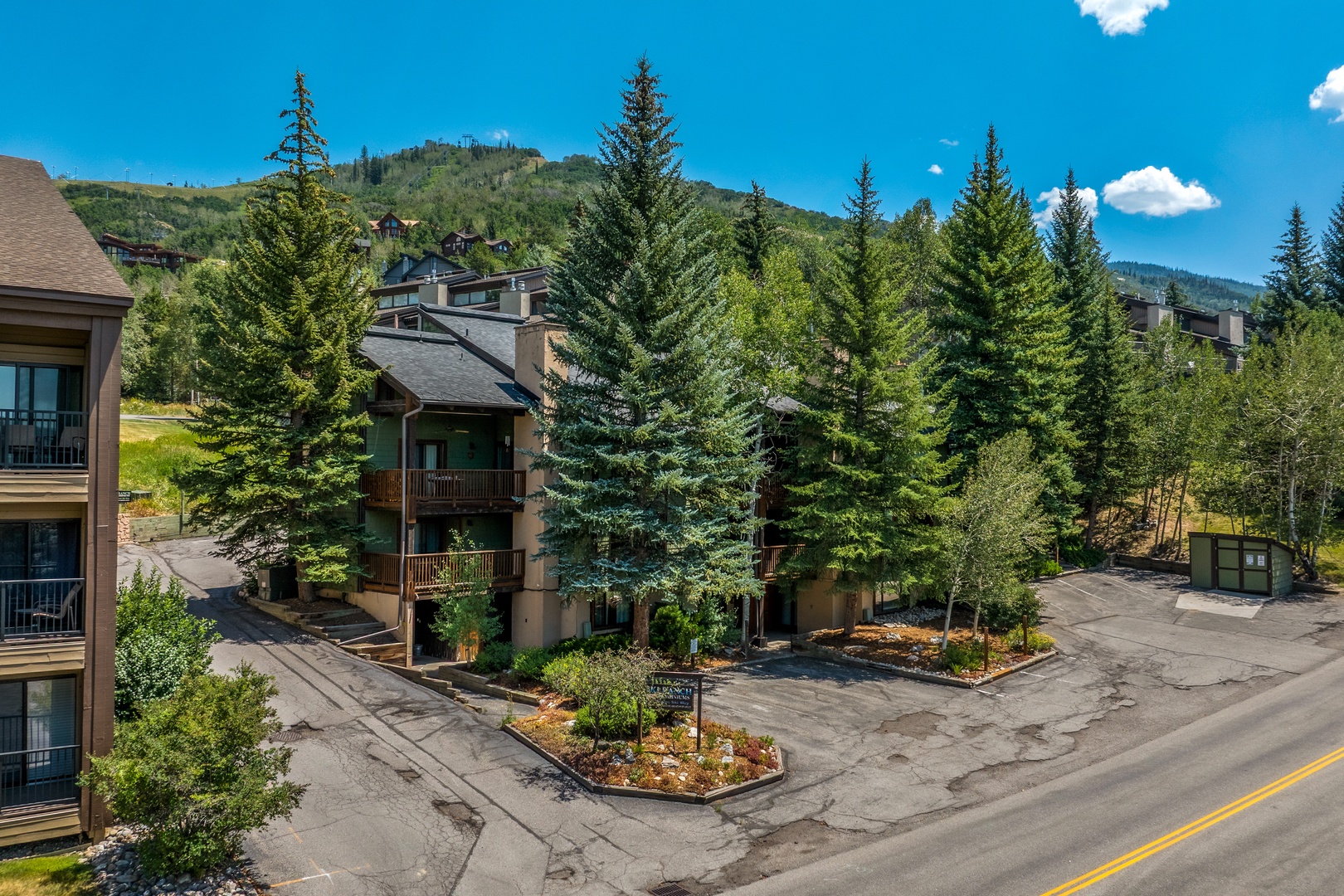 The property sits nestled among towering evergreens in a serene mountain community, with ski slopes and natural beauty surrounding your alpine retreat.