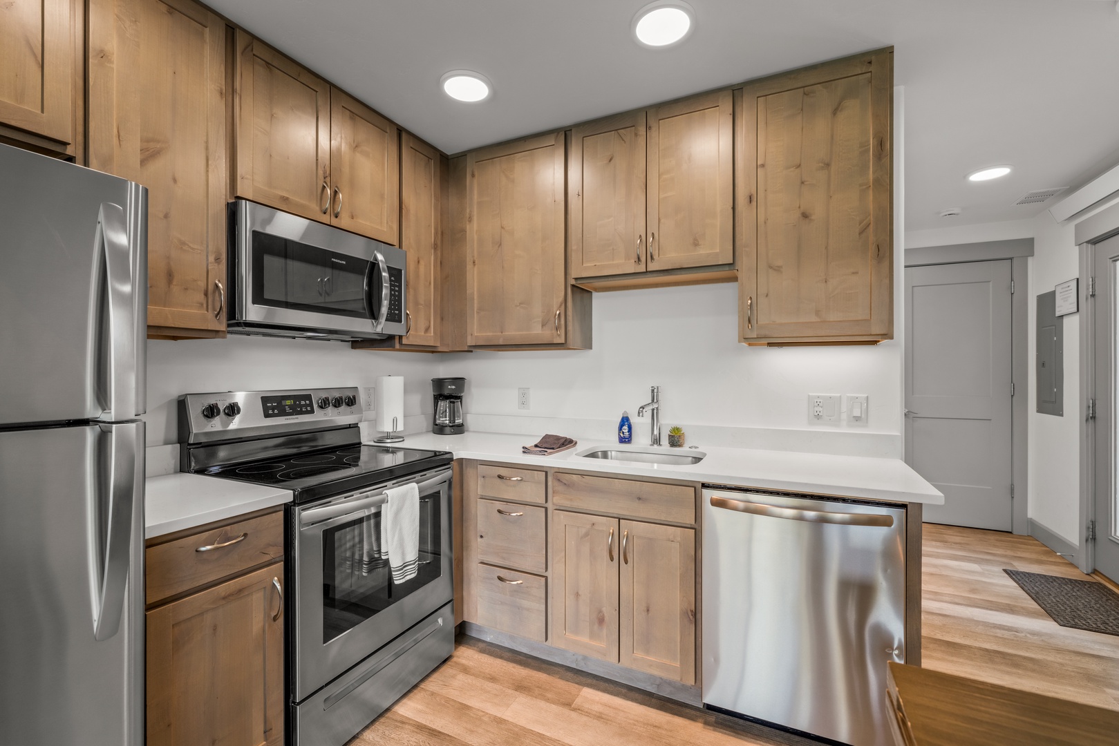 Your spacious kitchen welcomes you with warm wood cabinetry, modern stainless appliances, and bright countertops—perfect for whipping up vacation meals or your morning coffee.