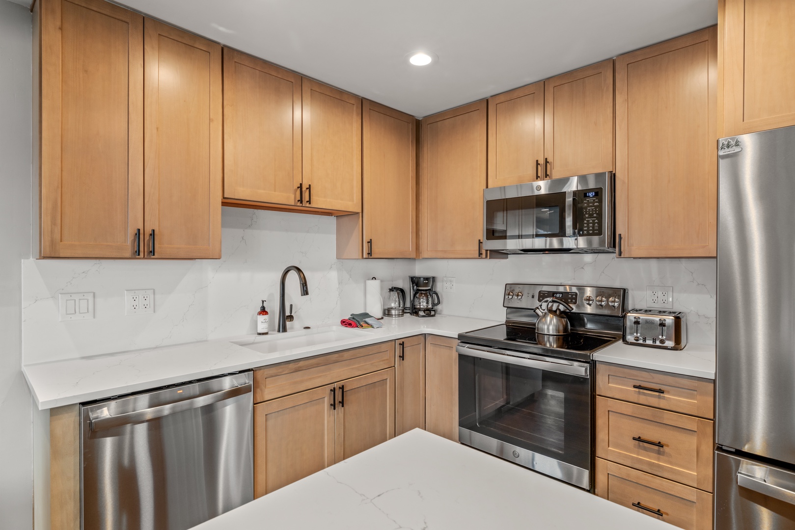 Your fully equipped kitchen features warm wood cabinetry, granite counters, and stainless steel appliances—perfect for preparing meals during your stay.