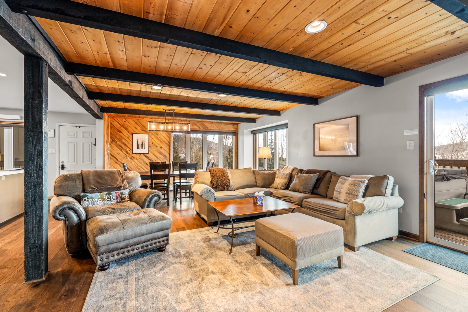 Unwind in your spacious living room with exposed beams, plush sectional seating, and mountain views streaming through large windows.