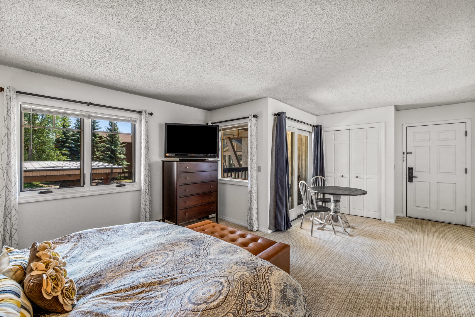 Your bright, spacious bedroom invites relaxation with its plush bed, charming window seat, and a cozy breakfast nook overlooking the backyard.