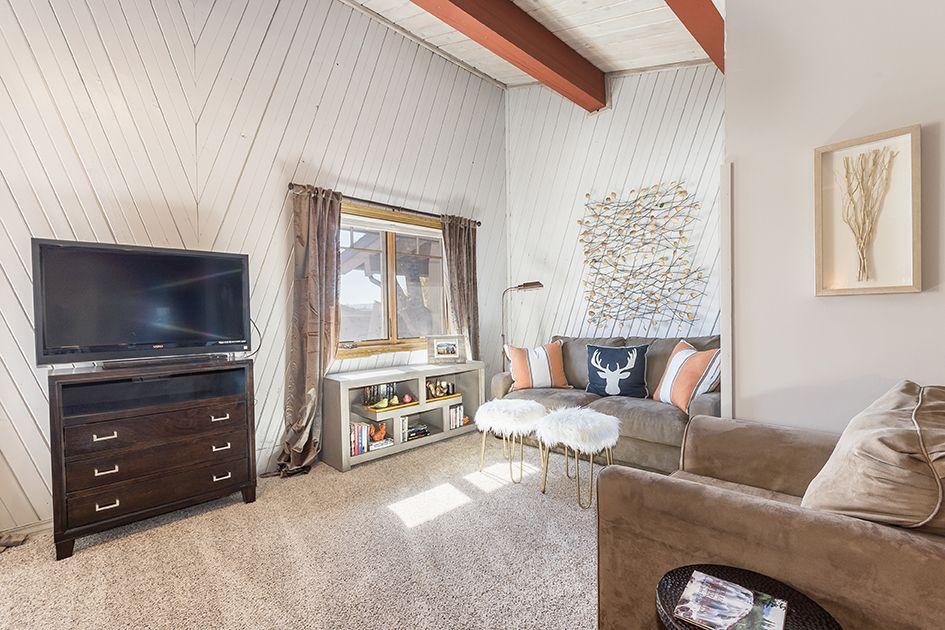 Unwind in your inviting living area, where rustic vaulted ceilings and cozy seating create the perfect space to relax after mountain adventures.