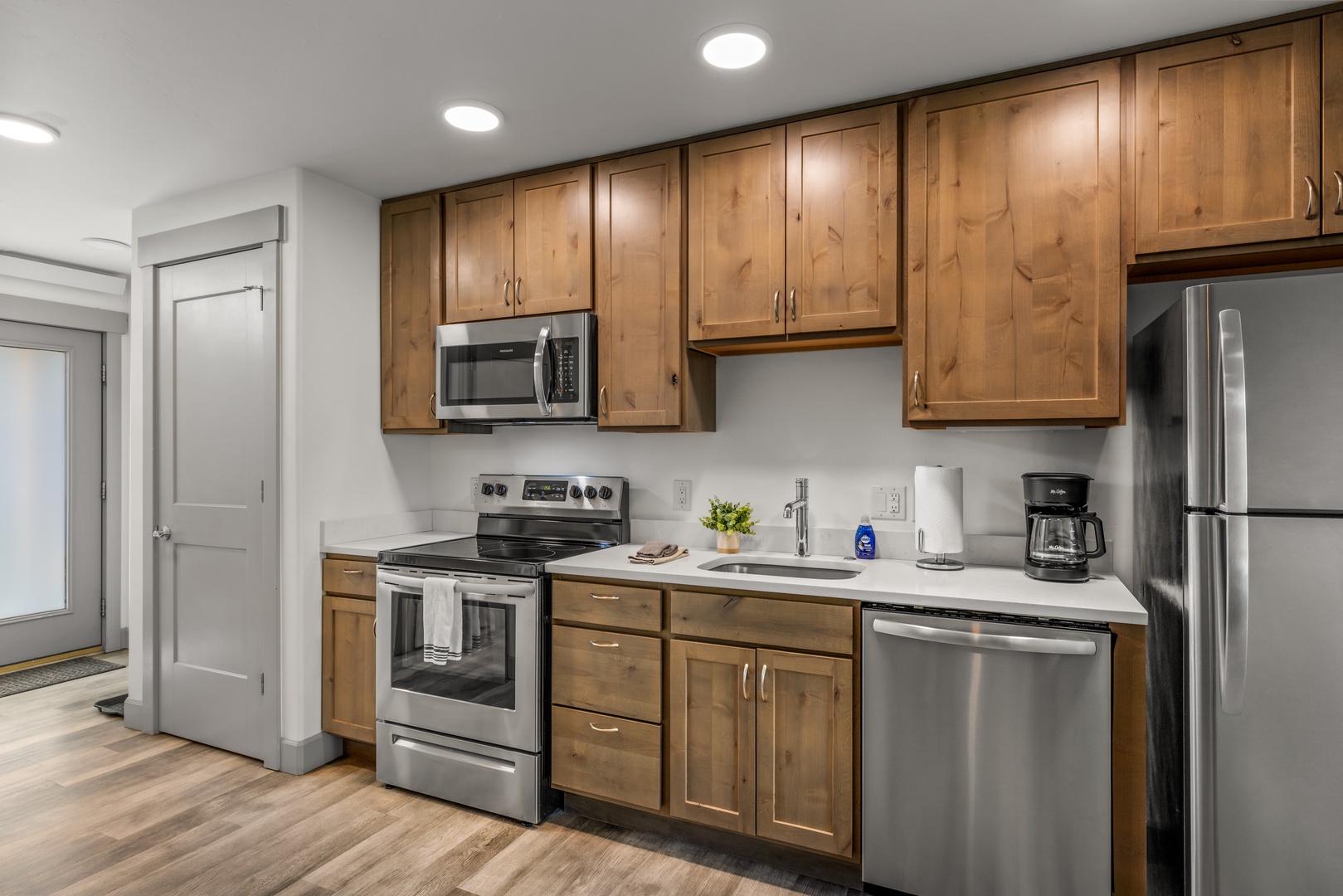 Step into your fully equipped kitchen with warm wood cabinetry, stainless steel appliances, and everything you need to whip up a delicious meal during your stay.