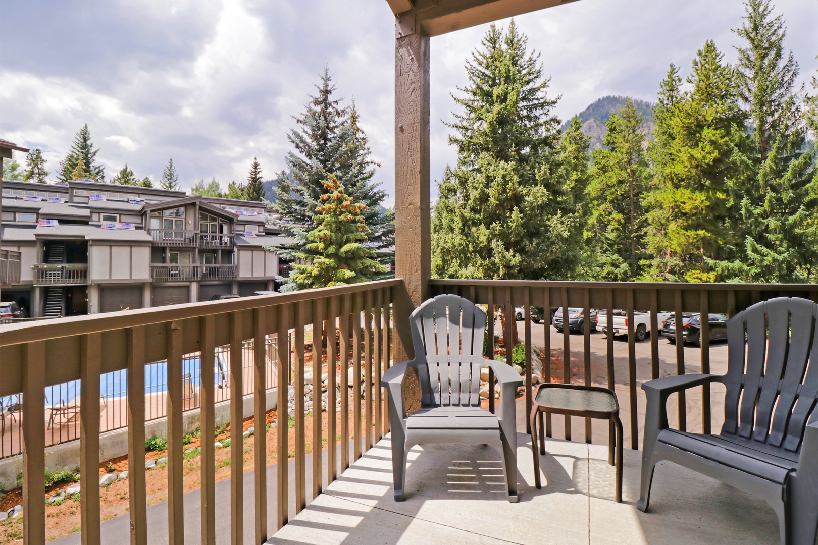 Step onto your private balcony and breathe in the crisp mountain air, surrounded by towering evergreens and peaceful views—your perfect retreat after a day of adventure.
