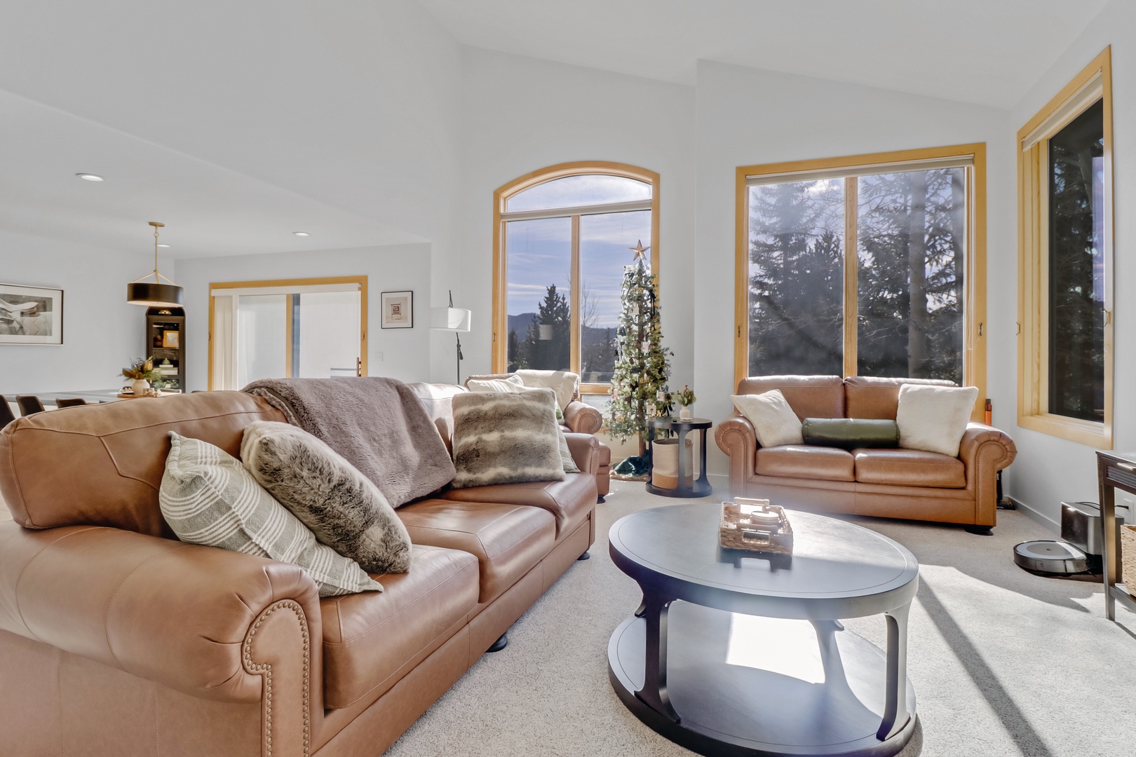 Sink into luxurious leather seating while natural light streams through stunning arched windows, creating your perfect retreat for relaxation.