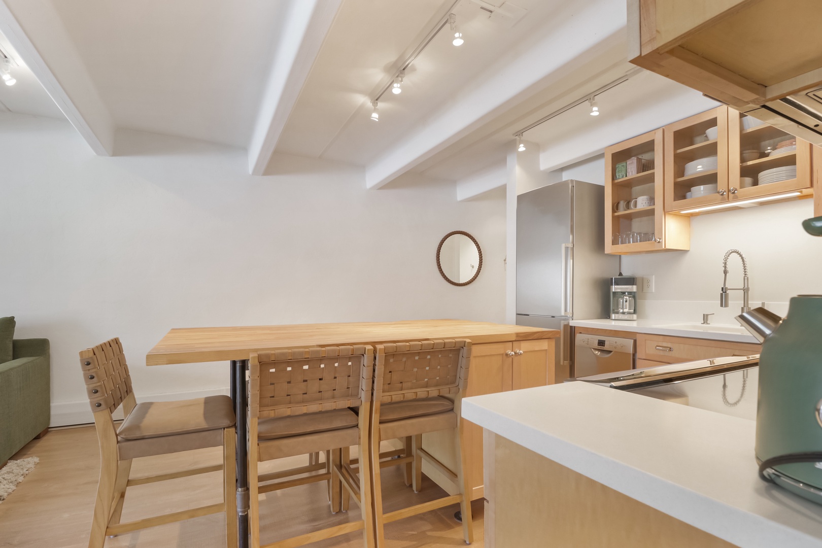 Your fully equipped kitchen features warm wood cabinetry, modern appliances, and a breakfast bar perfect for morning coffee or casual dining.