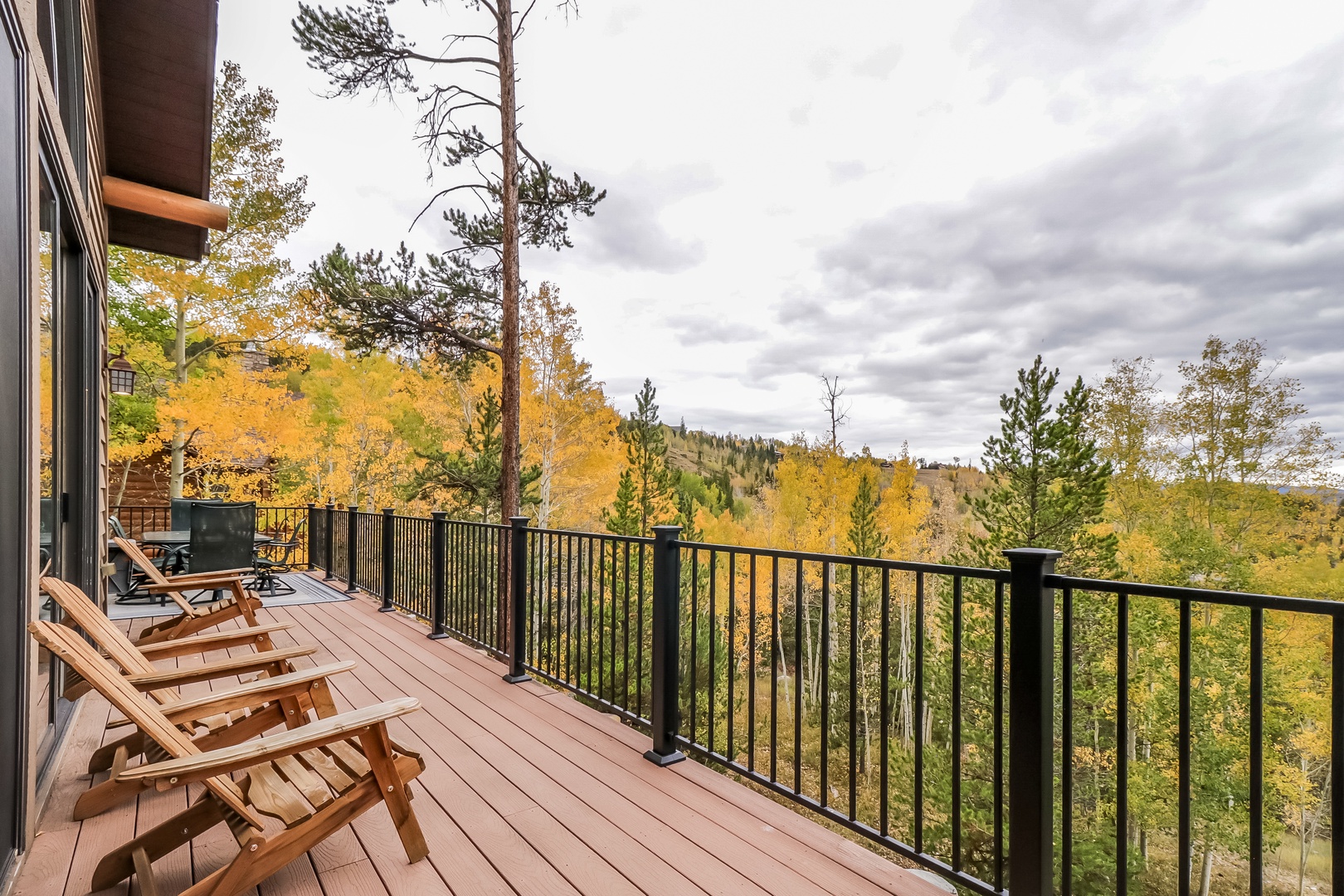A spacious deck with autumn foliage views, perfect for relaxing in the crisp mountain air and taking in the vibrant fall colors.