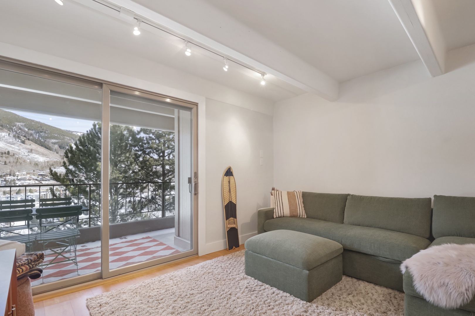 Settle into your cozy mountain retreat with a plush sectional sofa and stunning snow-capped views right outside your window.